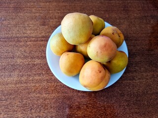 yellow apricots on a wooden table