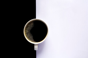 A cup of black coffee on a black and white background