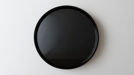 Black round wall mirror on white background