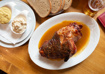Delicious grilled knuckle of pork with horseradish and mustard. Traditional czech dish