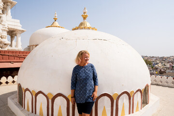 Young European tourist standing on the Hindu temple roof in Bikaner, Rajasthan, India