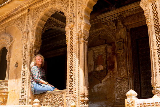 Young blonde European woman travelling in Rajasthan, exploring the old town of Jaisalmer, India