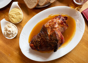 Fried pork knuckle (boar knee) with mustard and horseradish. Traditional czech dish. High quality photo
