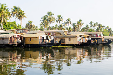 Obraz premium European tourist having a traditional straw houseboat ride on the backwaters of Kerala, India