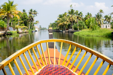 European tourist having a traditional straw houseboat ride on the backwaters of Kerala, India