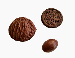 two chocolate cookies and chocolate eggs on a white background