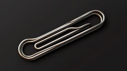 Obraz premium Elegant Metal Paper Clip with Detailed Design and Textured Lines