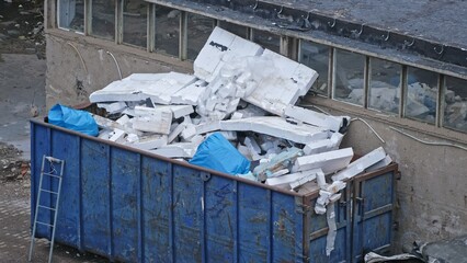 Large Industrial Garbage Container Filled with Pieces of Styrofoam Insulation from Building...