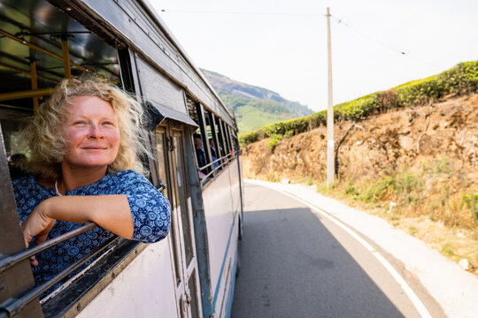 Female tourist having a bus ride from Munnar to Marayoor along tea plantations in Kerala, India