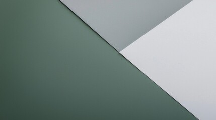 Intersecting green, grey, and white papers create an abstract geometric composition with diagonal lines, embodying a modern minimalist aesthetic for backgrounds and graphic design