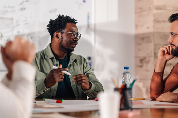 Marketing team brainstorming new ideas during office meeting