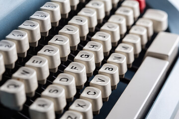 Old typewriter white keyboard detail with many letters in white buttons