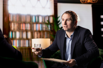 Secret service manager presenting important case files details over a glass of whiskey, meeting with a CIA agent to share insight and collaborate on national safety mission. Intelligence agency.