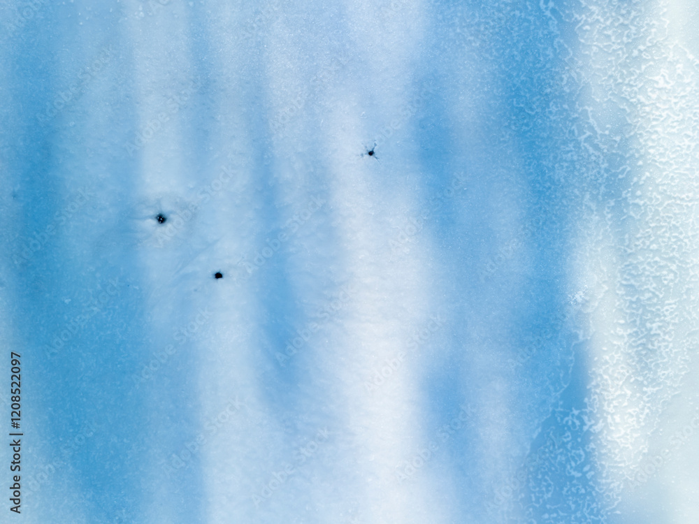 Poster a close-up view of a textured blue surface with small black spots creating a soothing and calming vi