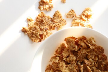 Corn flakes in a plate on a white background, close up