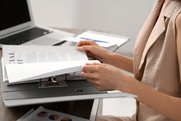 Young businesswoman working with documents in office. Closeup