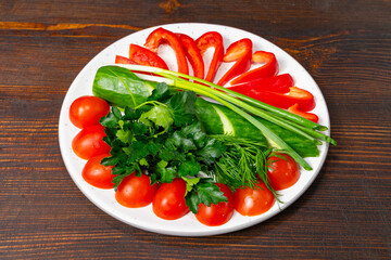 Colorful assortment of fresh vegetables arranged on a plate for healthy eating Savory vegetable pie served with fresh garnishes