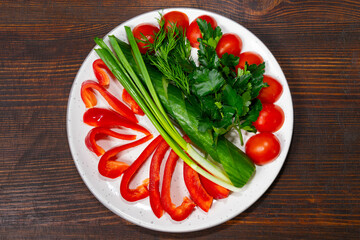 Colorful fresh vegetables arranged beautifully on a plate for a healthy meal Savory vegetable pie served with fresh garnishes on a white plate