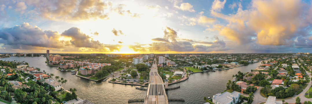 Boca Raton Florida Sunset. An aerial panoramic view over a drawbridge. Bright yellow and light blue colors in the sky. 