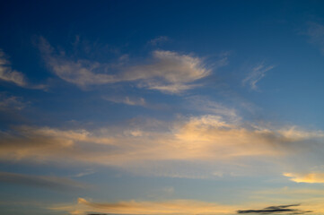 Twilight skies showcase delicate clouds and vibrant colors in a serene evening