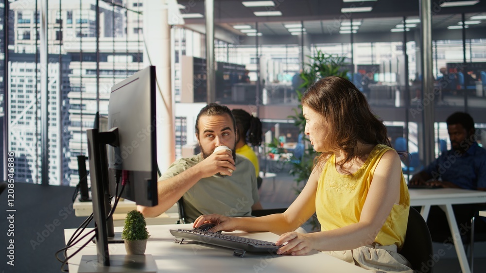 Poster man with paraplegia drinking coffee, checking progress done by employee doing code review to fix bug