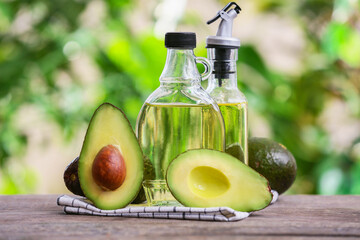 Bottles of avocado oil on table outdoors