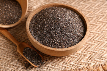 Bowls and scoop with chia seeds on napkin, closeup