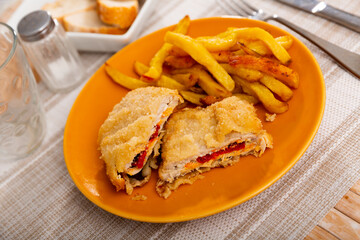 Popular dish of Spanish cuisine is goat cheese and pepper booklets, served with French fries