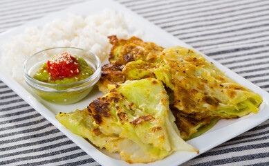 Battered cabbage leaves with rice served with tomato and avocado sauces