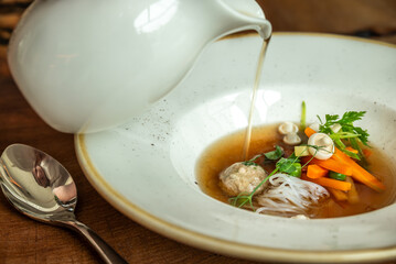 Gourmet broth with vegetables and meatball

