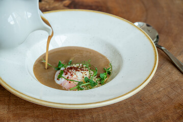 Gourmet soup with soft-poached egg and herbs
