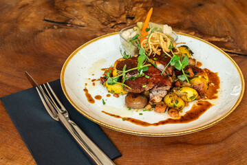Gourmet roasted meat with vegetables and sauce
