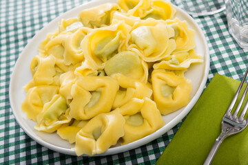 Delicious appetizing tortelloni with ricotta cheese and spinach. High quality photo