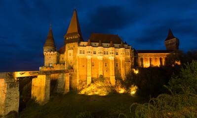 Fototapeta premium Corvin Castle is on the green mountain in night of Romania.