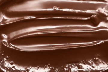 Glossy melted milk chocolate as background