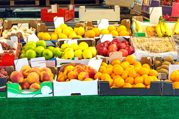Fresh organic fruits piles outside on a market stall
