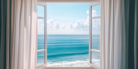 Ocean view from a sunlit room with open windows and flowing curtains during a clear day