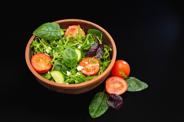 Fresh salad with tomatoes, basil, lettuce and olive oil. healthy food.
