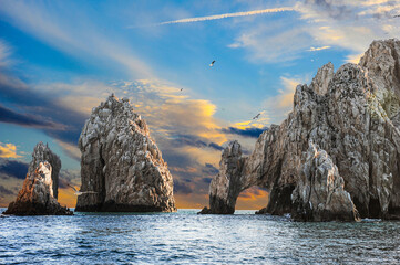 Seagulls at sunset in front of Cabo San Lucas, Mexico's El Arco Arch.