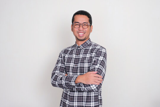 Adult Asian man standing confident with arms crossed