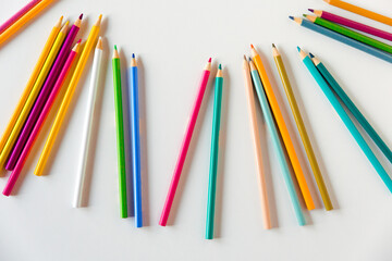 Сolored pencils on a white background. Copy space, mockup, flat lay. Art, creativity, education concept