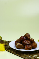 Sukkari Dates Fruits on isolated background. Breakfasting concept in Ramadan month. Islamic template for text background. 

