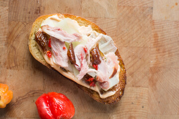 Overhead view of open sandwich with smoked chicken peppers and cucumber slices,  top view of sandwich appetizer