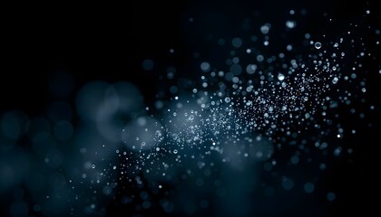 A fine mist of water droplets suspended in the air, captured in a macro shot against a deep black background