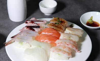 Various sushi on a white plate. A close-up shot of fresh seafood dishes.
