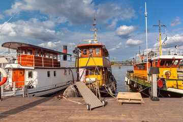 Old boats moored at the embankment in Stockholm, Sweden