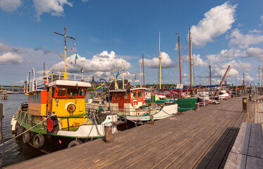 Old boats moored at the embankment in Stockholm, Sweden