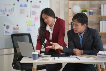 Two businessmen working with accounting, finance, banking business and laptops with financial analysis reports in a meeting, discussing and exchanging knowledge. Presentation about office work