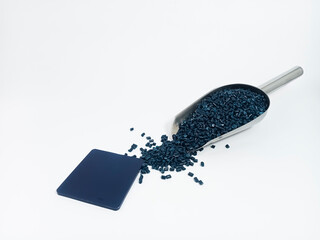 Dark blue masterbatch, polymer granules carrying pigment inside stainless steel scope, isolated on...