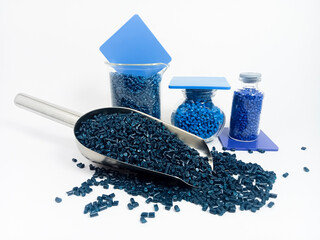 Dark blue masterbatch, polymer granules carrying pigment inside stainless steel scope, isolated on...
